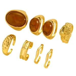 Detail view of a 7-piece vintage gold ring set featuring amber stones and irregular textures