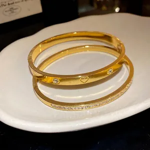 Elegant vintage gold-plated stainless steel bangle set with heart and zirconia stones inlay