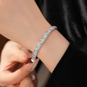 Elegant silver bangle inlaid with sparkling teal and clear zircon stones
