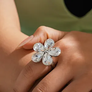 Close-up of elegant silver flower ring featuring five sparkling teardrop-shaped crystals