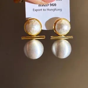 18k gold plated stud earrings with brushed silver sphere and pearl accent