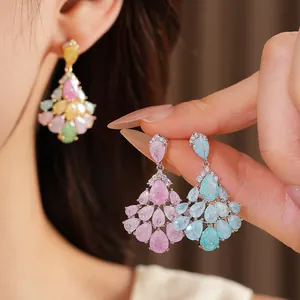Macro view of 14k gold-plated teardrop fan chandelier earrings with colorful zirconia