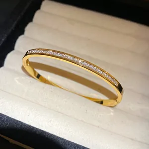 Detail of elegant gold stainless steel bangle featuring channel-set cubic zirconia stones.