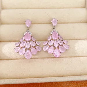 Close-up detail of 14k gold plated fan-shaped earrings with sparkling pink cubic zirconia