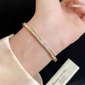Close-up of a gold stainless steel bangle with square zircon inlay on wrist
