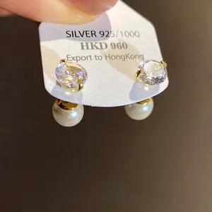 Elegant gold-tone front-back earrings featuring white pearls and sparkling zircons