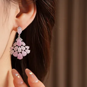 Close-up view of elegant pink teardrop fan-shaped dangling earrings with 14k gold plating