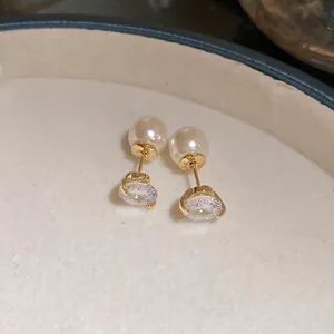 Elegant gold-tone two-way earrings with white pearls and oval cubic zirconia studs.