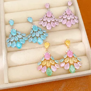 Close-up of 14k gold plated fan-shaped earrings with colorful teardrop zircon stones.