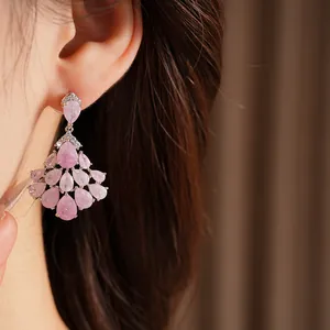 Close-up of elegant pink teardrop fan-shaped zircon earrings with 14k gold plating.