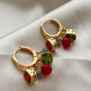 Detail view of 18K gold plated hoop earrings with colorful zircon and stone drops