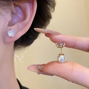 Detailed macro view of two-way wear stud earrings with gold finish, pearl, and zircon