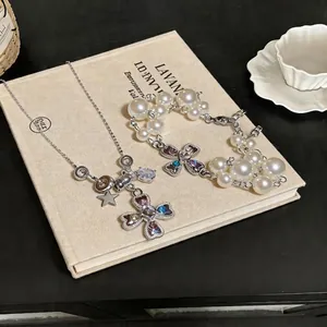 Elegant silver-toned cross necklace and pearl bracelet set with colorful zircon stones