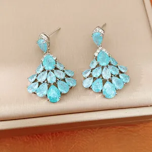 Close-up of elegant blue teardrop zircon cluster earrings with silver-toned plating