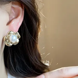 Detailed close-up of vintage French style flower pearl stud earring with elegant gold finish