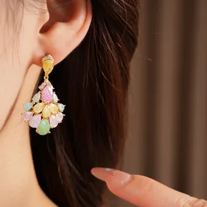 Close-up of elegant 14k gold plated chandelier earrings with colorful teardrop stones