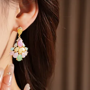 Close-up of elegant 14k gold plated drop earrings with colorful teardrop stones