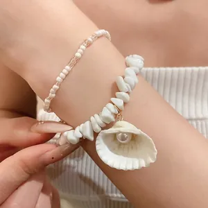 Summer beach style beaded bracelet set with white shell charm and pearl detail