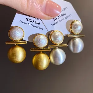 Detailed view of 18k gold plated brushed texture round pearl stud earrings set.
