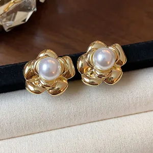 Close-up of vintage flower pearl stud earrings with 13k gold plating