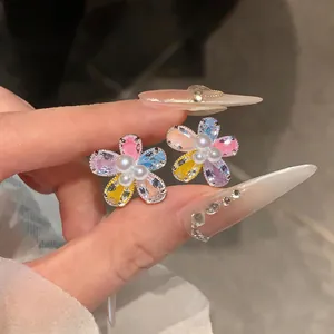 Detailed view of sweet flower stud earrings featuring colorful zircons and white pearls
