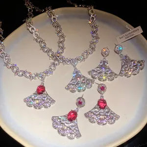 Luxurious fan-shaped jewelry set with red oval stones and sparkling cubic zirconia detail