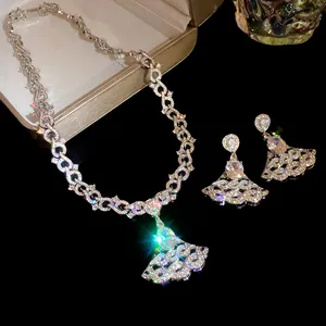 Macro view of the elegant zircon pendant necklace and matching fan-shaped earrings