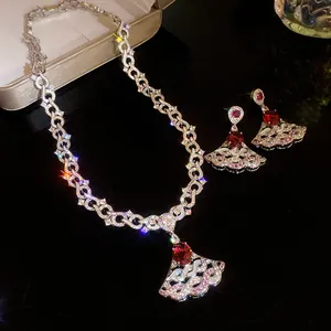 Detailed close-up view of elegant zircon necklace and earring set with red gemstone pendants