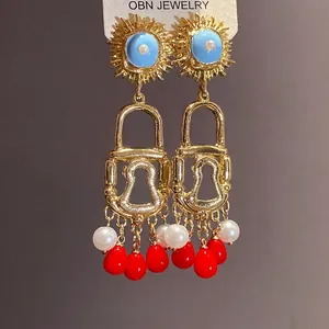 Vintage bohemian style enamel sun and padlock drop earrings with red bead charms