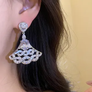 Detailed close-up of silver-tone fan-shaped drop earrings with brilliant cubic zirconia stones.
