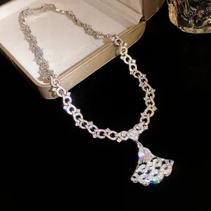 Detailed close-up view of an elegant silver-colored zircon necklace with a fan-shaped pendant
