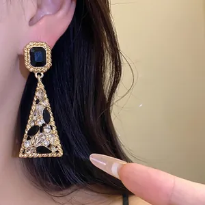 Elegant vintage-style gold triangle dangle earrings with black and clear rhinestones