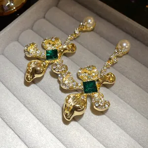 Vintage style silver needle gold floral earrings with emerald green crystals and pearls.