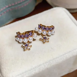 Elegant gold ear clips with purple stones, white pearls and dangling star charms