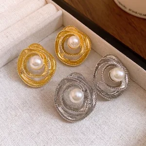 Vintage twisted round stud earrings with pearl center in gold and silver metallic finish