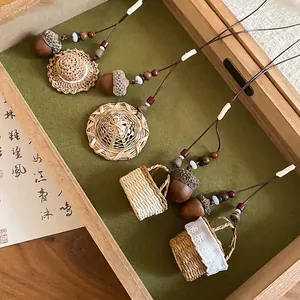 Handcrafted New Chinese style acorn and straw hat pendant necklaces in a wooden tray
