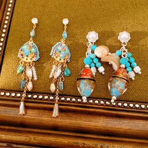 Detailed macro view of vintage ethnic style earrings featuring glass beads and tassels