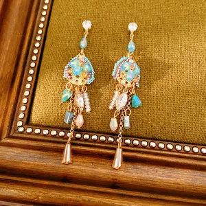 Macro view of vintage ethnic tassel earrings featuring colorful zircon and glass beads.