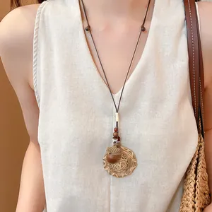 Close-up of a New Chinese style necklace featuring an acorn and woven hat pendant accessory