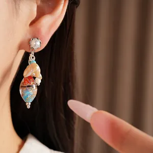 Detail shot of vintage glass tassel earrings with colorful foil beads and pearls