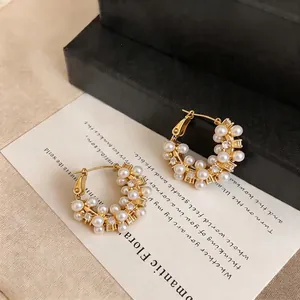 Elegant gold-plated hoop earrings decorated with white pearls and sparkling zircons for women
