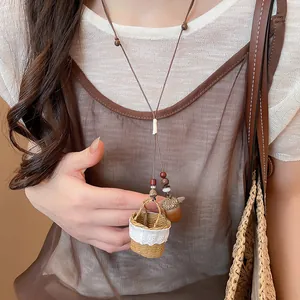 Close-up of handmade woven basket and acorn pendant necklace in woodland style