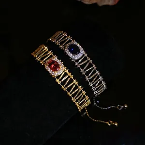 Vintage oval zircon hollow bracelets in gold and silver finish on black velvet display