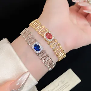 Close-up detail of vintage gold and silver bracelets with oval zircon stones on wrist
