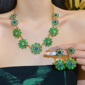 Retro palace style jewelry set with green rhinestone floral necklace and earrings on model