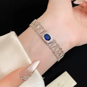 Detailed view of a vintage oval blue zircon bracelet with hollow-out silver band