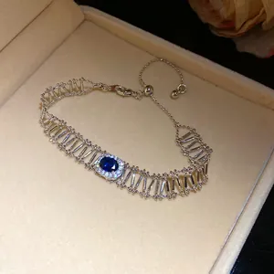 Detailed macro view of vintage hollow bracelet with blue oval zircon centerpiece