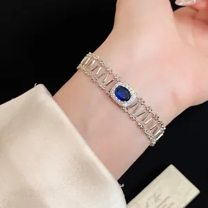 Detail of vintage-style hollow silver bracelet with an oval blue zircon stone.