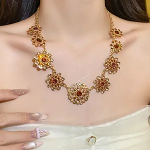 Vintage gold-toned necklace with amber crystal floral pendants in a regal court style