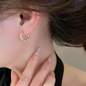 Elegant close-up of a silver lace hoop earring with zircon on ear, Korean jewelry style.